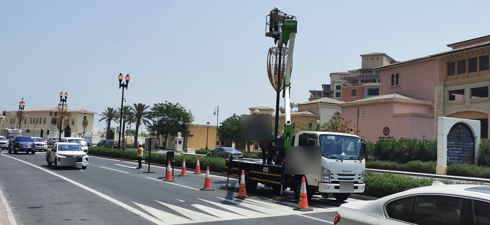 Work at height from a truck-mounted platform with traffic cones on a live road